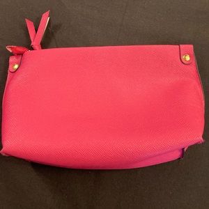 Macy's bright pink zippered makeup bag.